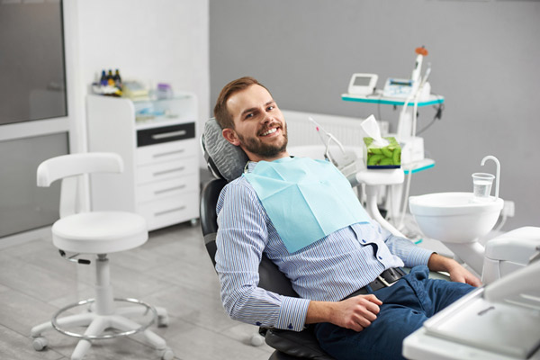 A man in a dental chair preparing for ridge augmentation