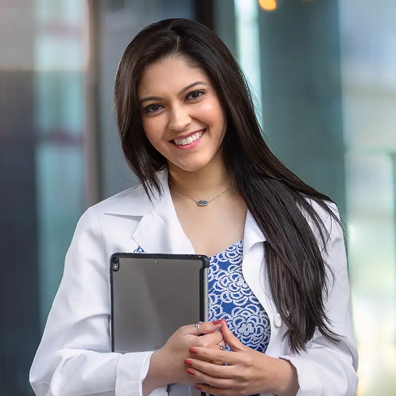 Smiling doctor holding clipboard