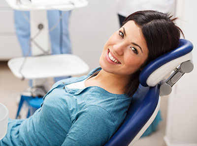 Woman in dental chair before wisdom tooth removal from Mountain State Oral and Facial Surgery in Parkersburg, WV