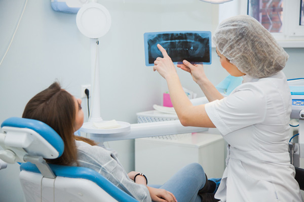 A woman reviewing her xray with a surgeon at Mountain State Oral and Facial Surgery in Charleston, WV