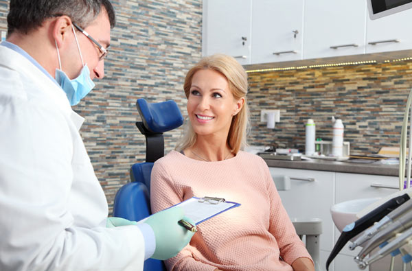 Woman talking to surgeon about post operative instructions