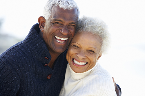 Black couple smiling after learning about the types of dental implants done at Mountain State Oral and Facial Surgery in Princeton, WV 