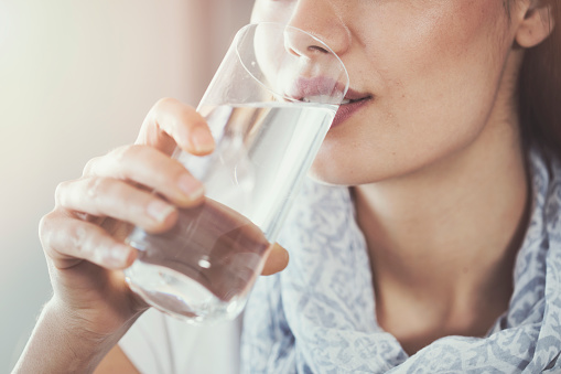 Close up of woman rinsing her mouth with salt water at Mountain State Oral and Facial Surgery in Charleston, WV